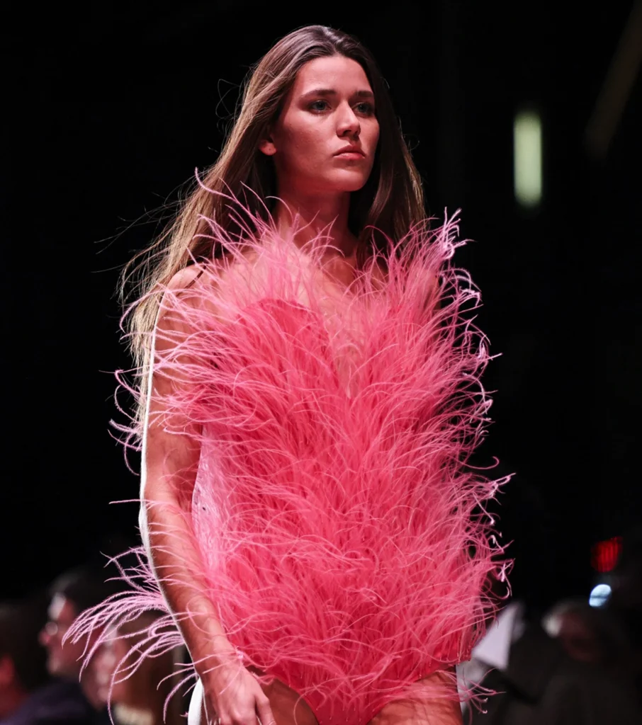 Model wearing a bright pink bodysuit made with Fevvers’ plant-based feather alternative in Stella McCartney’s Paris Fashion Week show.