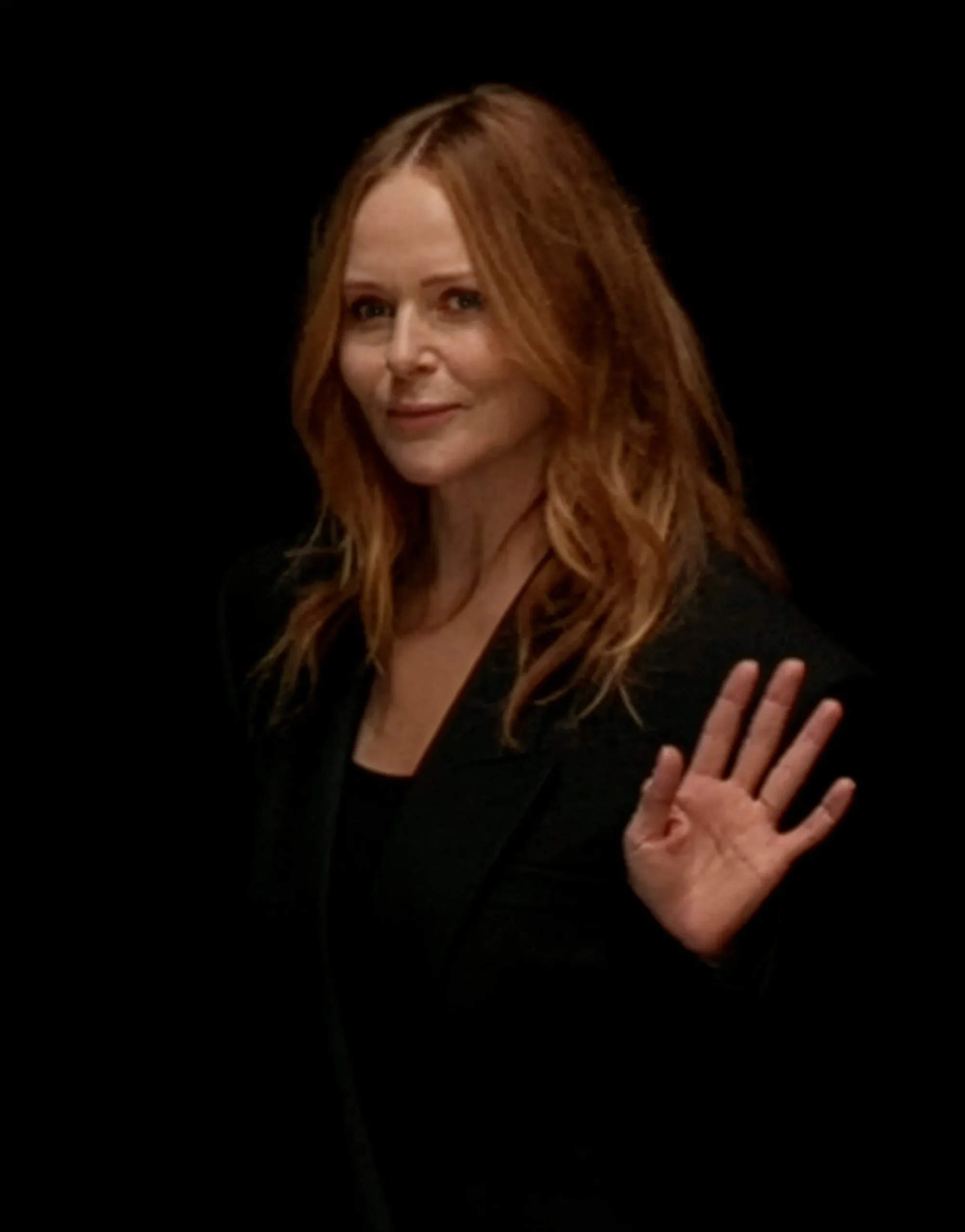 Stella McCartney waving at the audience at the close of her Paris Fashion Week show featuring Fevvers’ plant-based feather alternative.
